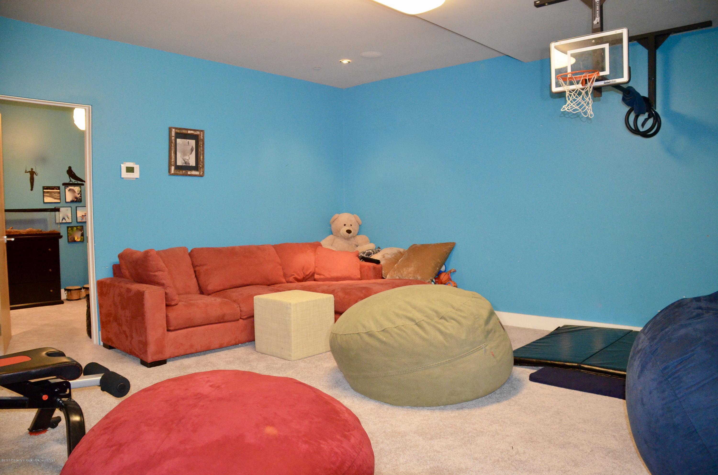 80 Riverdown Drive Aspen, CO 81611 - Photo 24 of 31 a bedroom with a bed and dresser