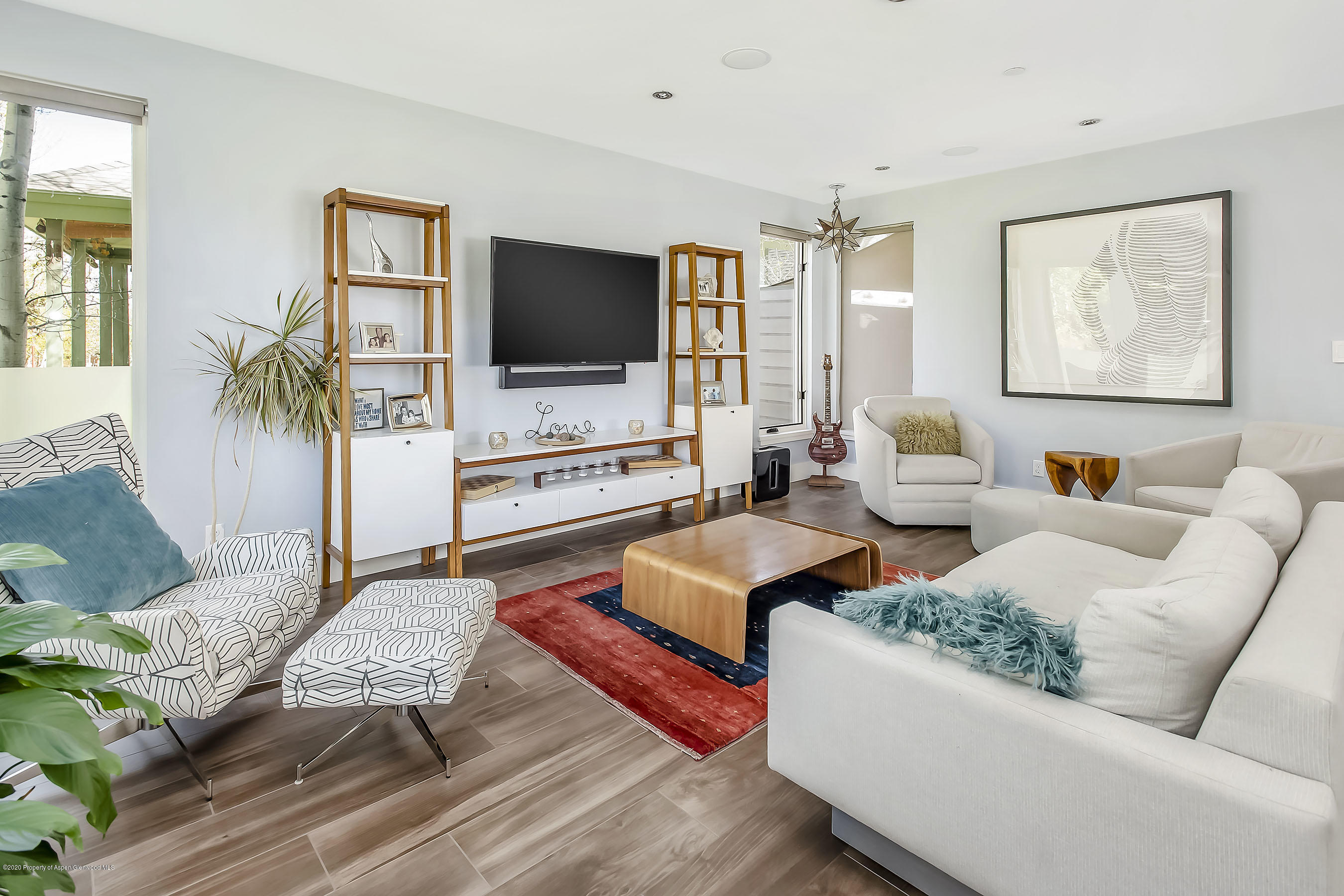 80 Riverdown Drive Aspen, CO 81611 - Photo 3 of 31 a living room with furniture and a flat screen tv