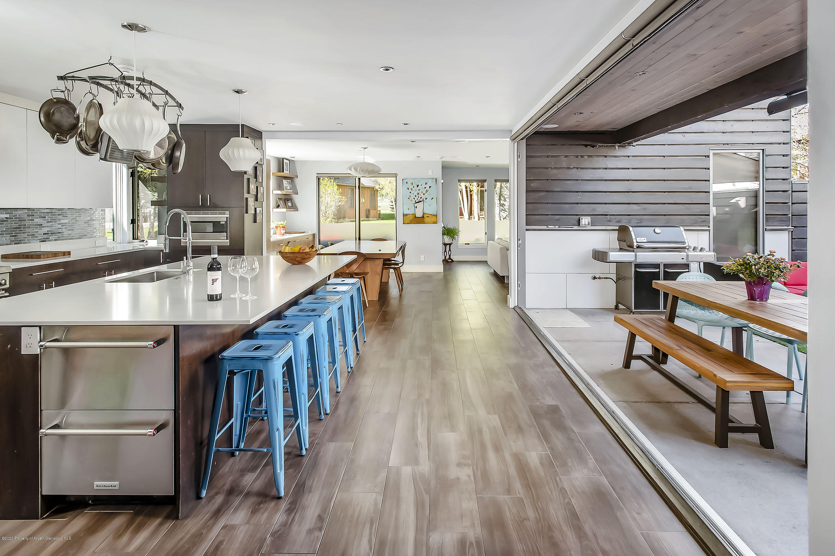 80 Riverdown Drive Aspen, CO 81611 - Photo 9 of 31 a dining room with wooden floor and large windows