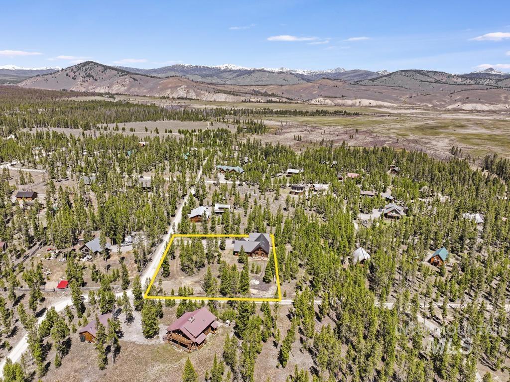 65 Goat Creek Way Stanley, ID 83278 - Photo 32 of 32 Aerial perspective showcasing a property surrounded by mature evergreen trees