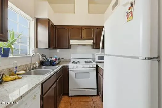 a kitchen with a stove top oven sink and cabinets