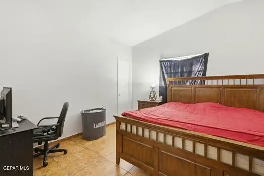 a bedroom with a bed and a desk