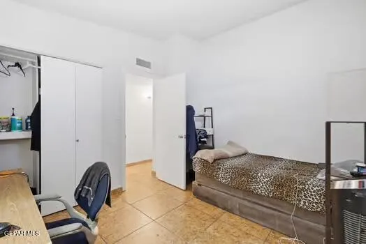 a bedroom with a bed and a chair