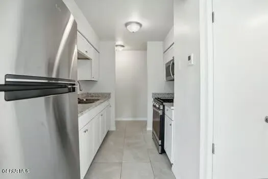a kitchen with a refrigerator and a stove