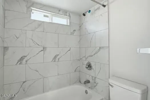 a bathroom with a bathtub and shower