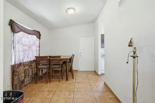a dining room with furniture and a rug