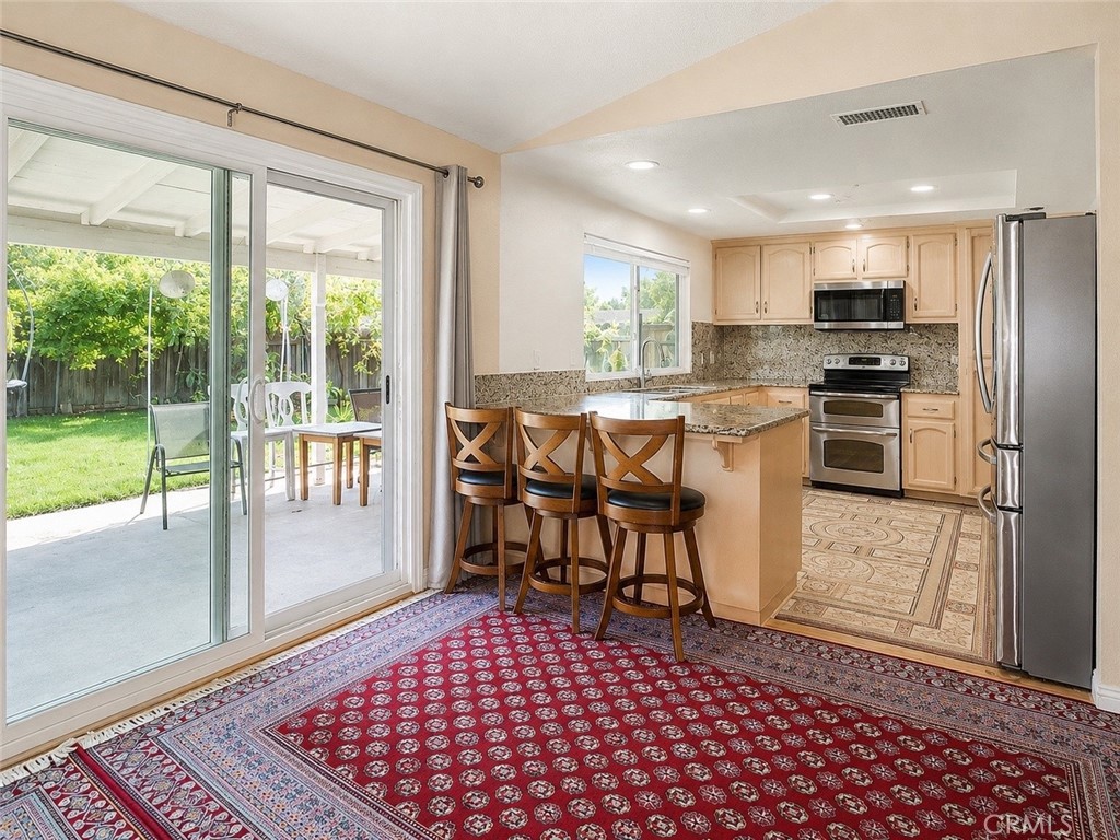 4100 Ahwahnee Court Modesto, CA 95356 - Photo 19 of 34 Open dining and kitchen area with easy access to the covered patio.