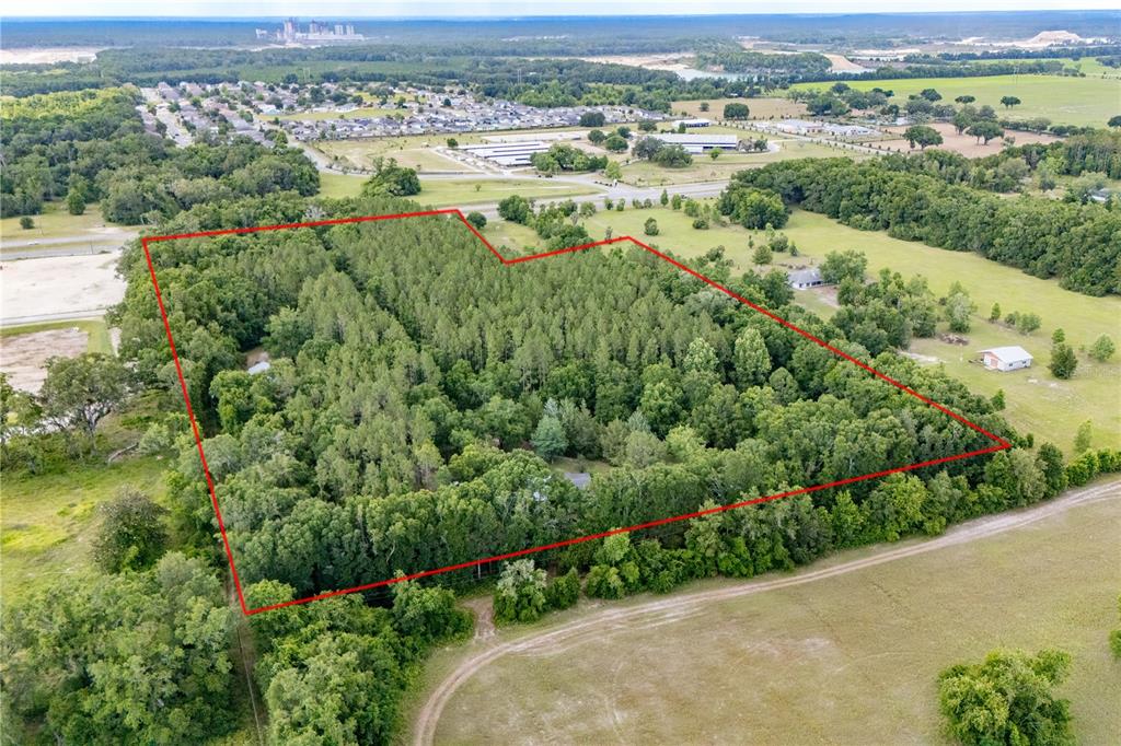 23227 West Newberry Road Newberry, FL 32669 - Photo 17 of 30 an aerial view of green landscape with trees houses and lake view