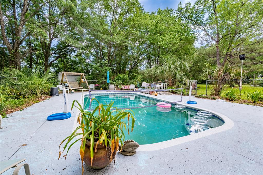 23227 West Newberry Road Newberry, FL 32669 - Photo 22 of 30 a view of a swimming pool with a patio