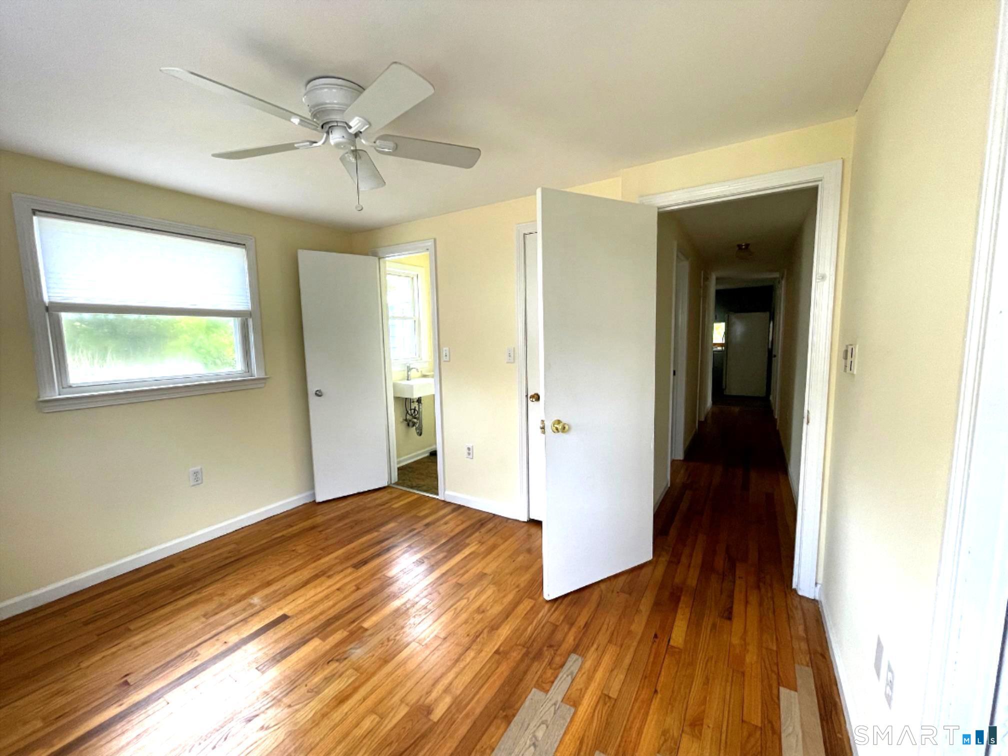 18 Old South Cove Road Old Saybrook, CT 06475 - Photo 30 of 40 a view of a room with wooden floor and a ceiling fan