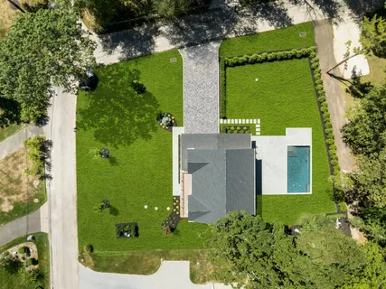 an aerial view of a residential houses with outdoor space