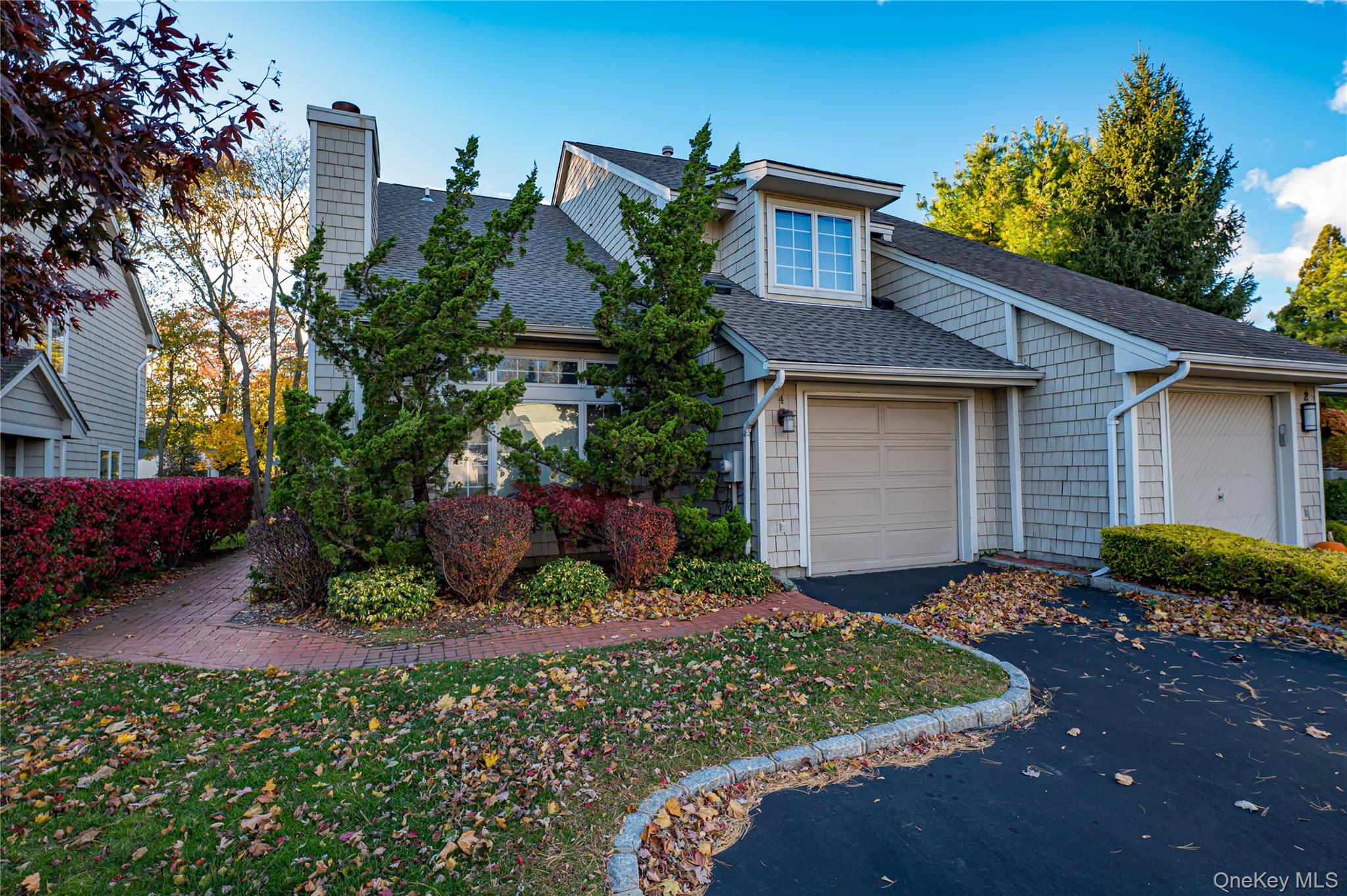 4 Cedar Ridge Lane Bay Shore, NY 11706 - Photo 1 of 1 a front view of a house with a yard and potted plants