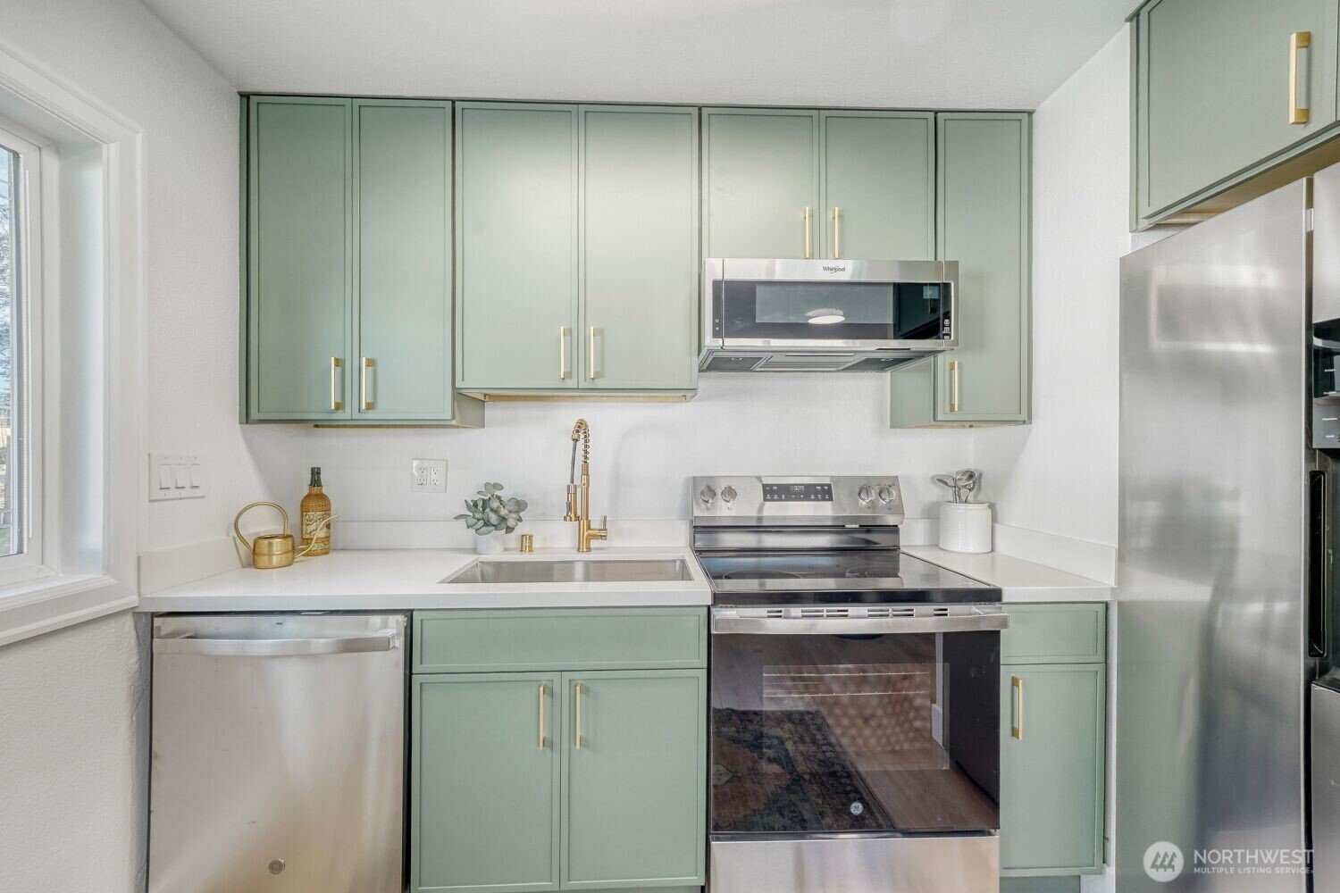 98056-768 Dayton Avenue Northeast Renton, WA 98056 - Photo 12 of 27 a kitchen with stainless steel appliances granite countertop a sink stove and refrigerator