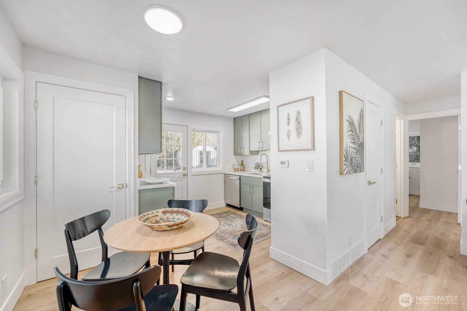 98056-768 Dayton Avenue Northeast Renton, WA 98056 - Photo 13 of 27 a view of a dining room with furniture and wooden floor