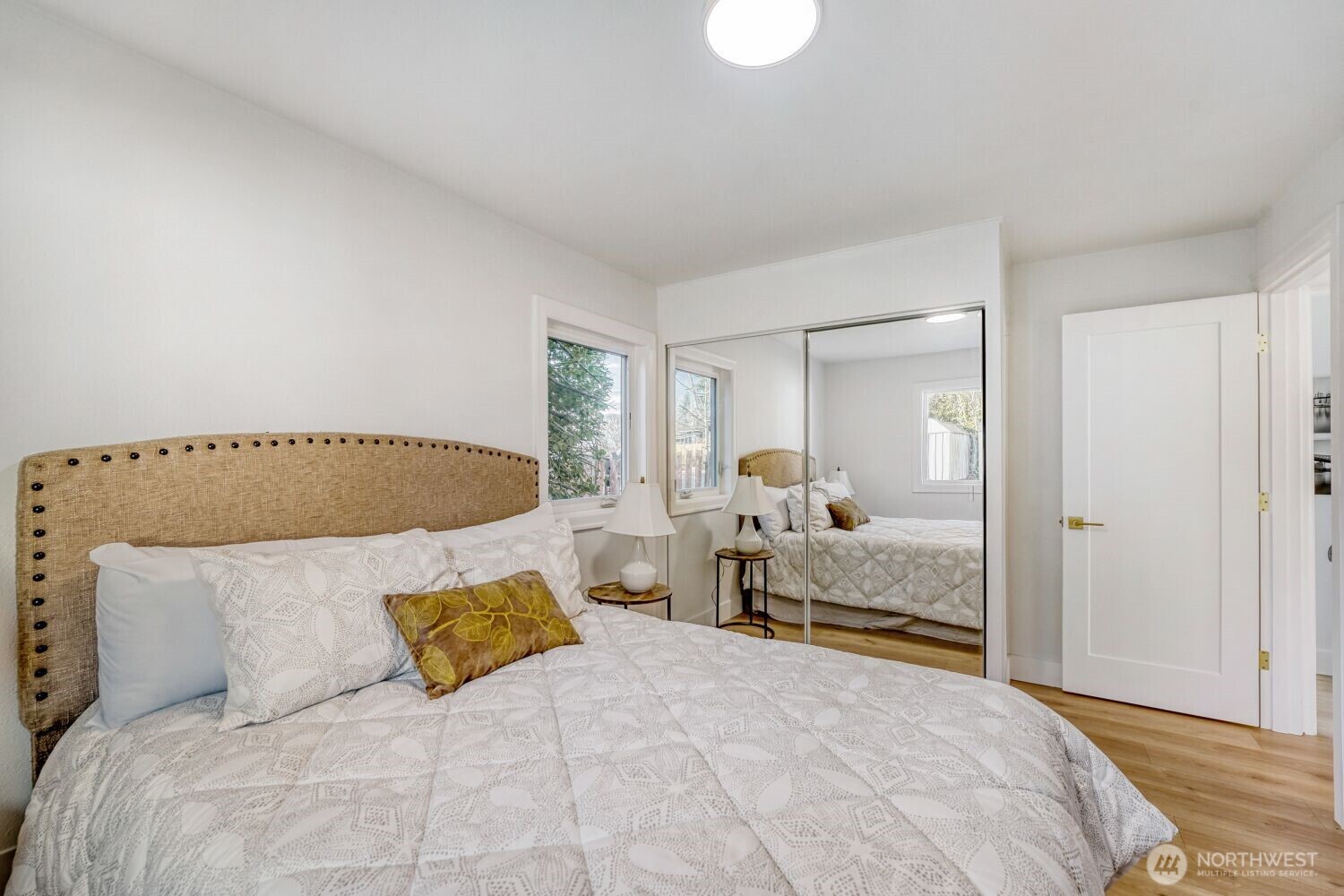 98056-768 Dayton Avenue Northeast Renton, WA 98056 - Photo 19 of 27 a bedroom with a bed and mirror