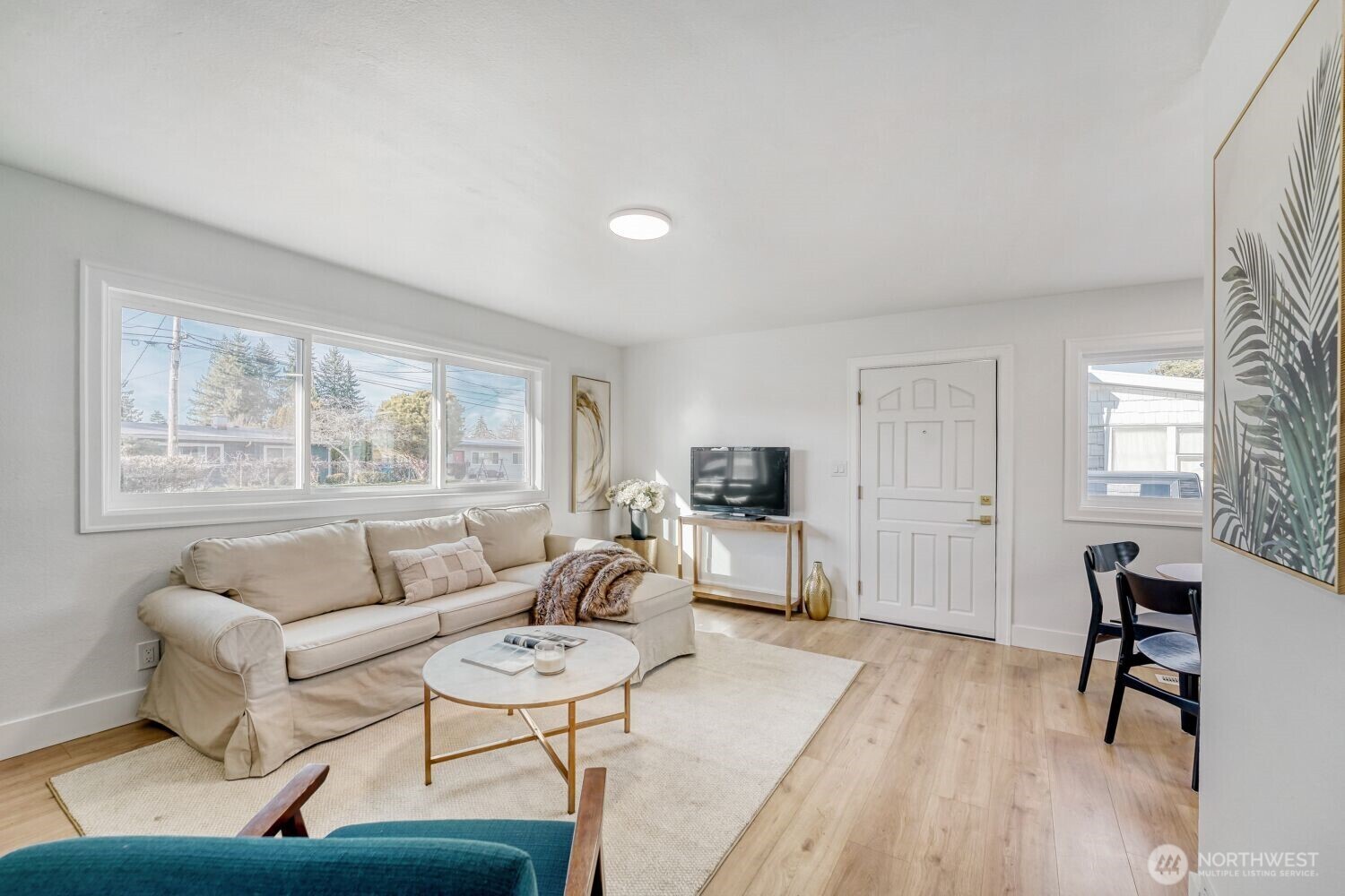 98056-768 Dayton Avenue Northeast Renton, WA 98056 - Photo 4 of 27 a living room with furniture and a flat screen tv with wooden floor