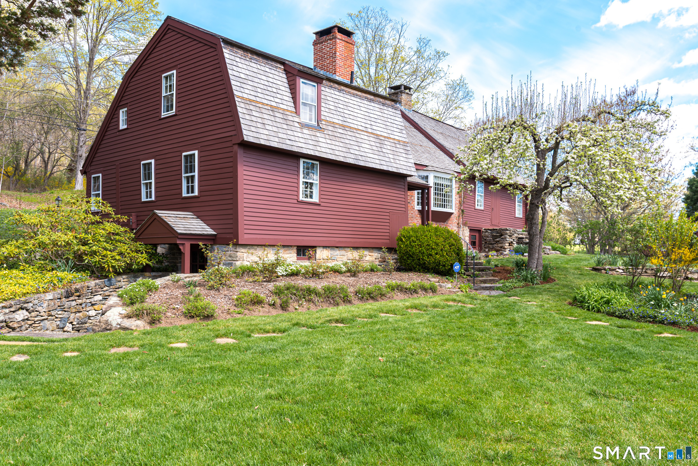 29 Spencer Road Haddam, CT 06441 - Photo 8 of 40 a brick house with a yard plants and large tree