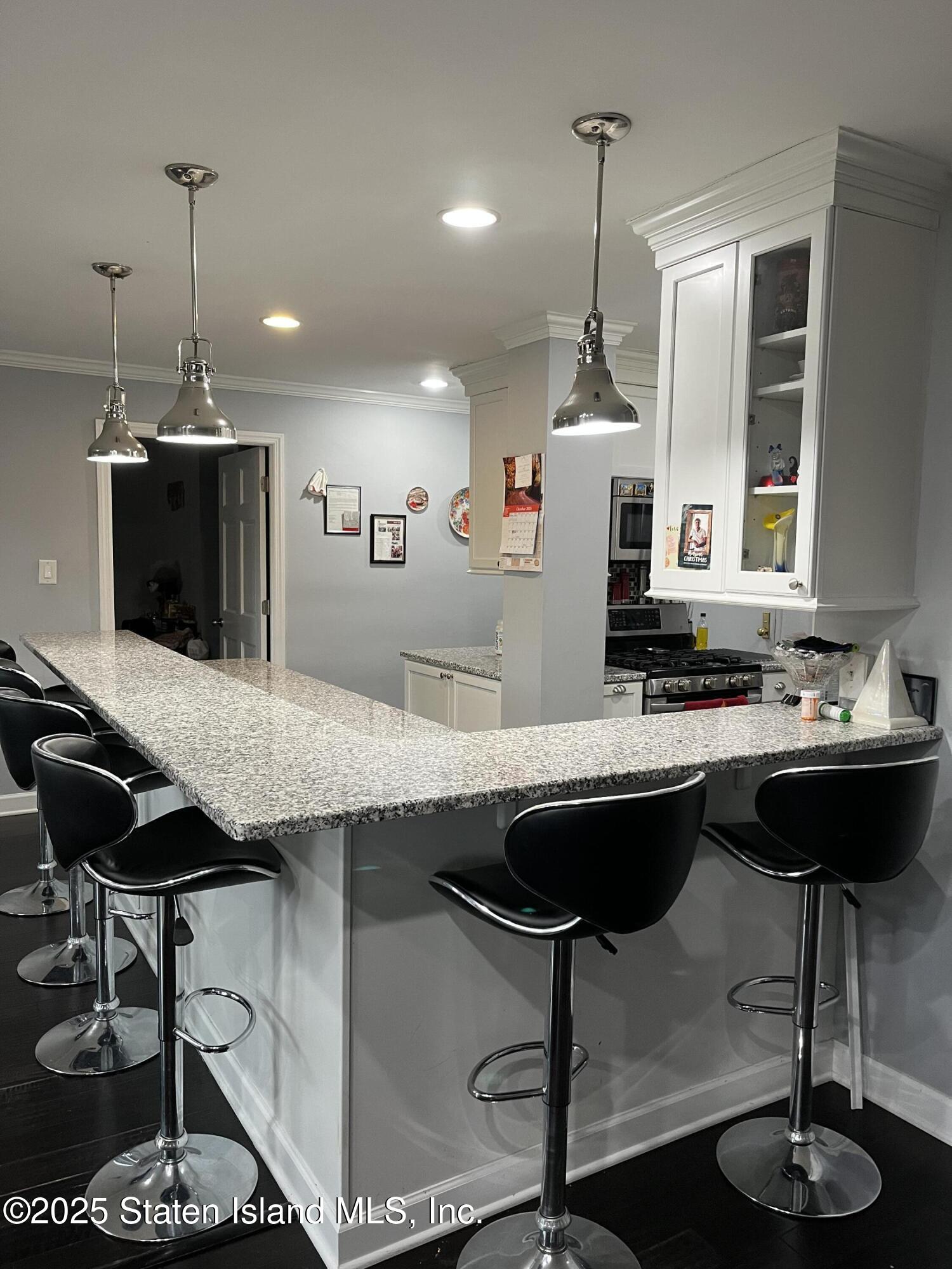 1000 Clove Road, Unit 6O & 6P Staten Island, NY 10301 - Photo 11 of 45 a kitchen with a center island appliances and cabinets