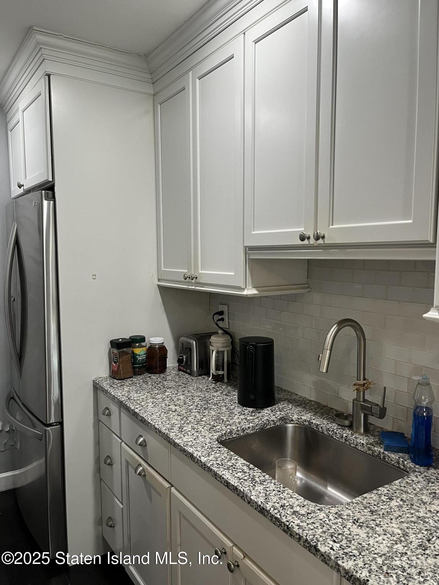 1000 Clove Road, Unit 6O & 6P Staten Island, NY 10301 - Photo 18 of 45 a kitchen with granite countertop a sink and a refrigerator
