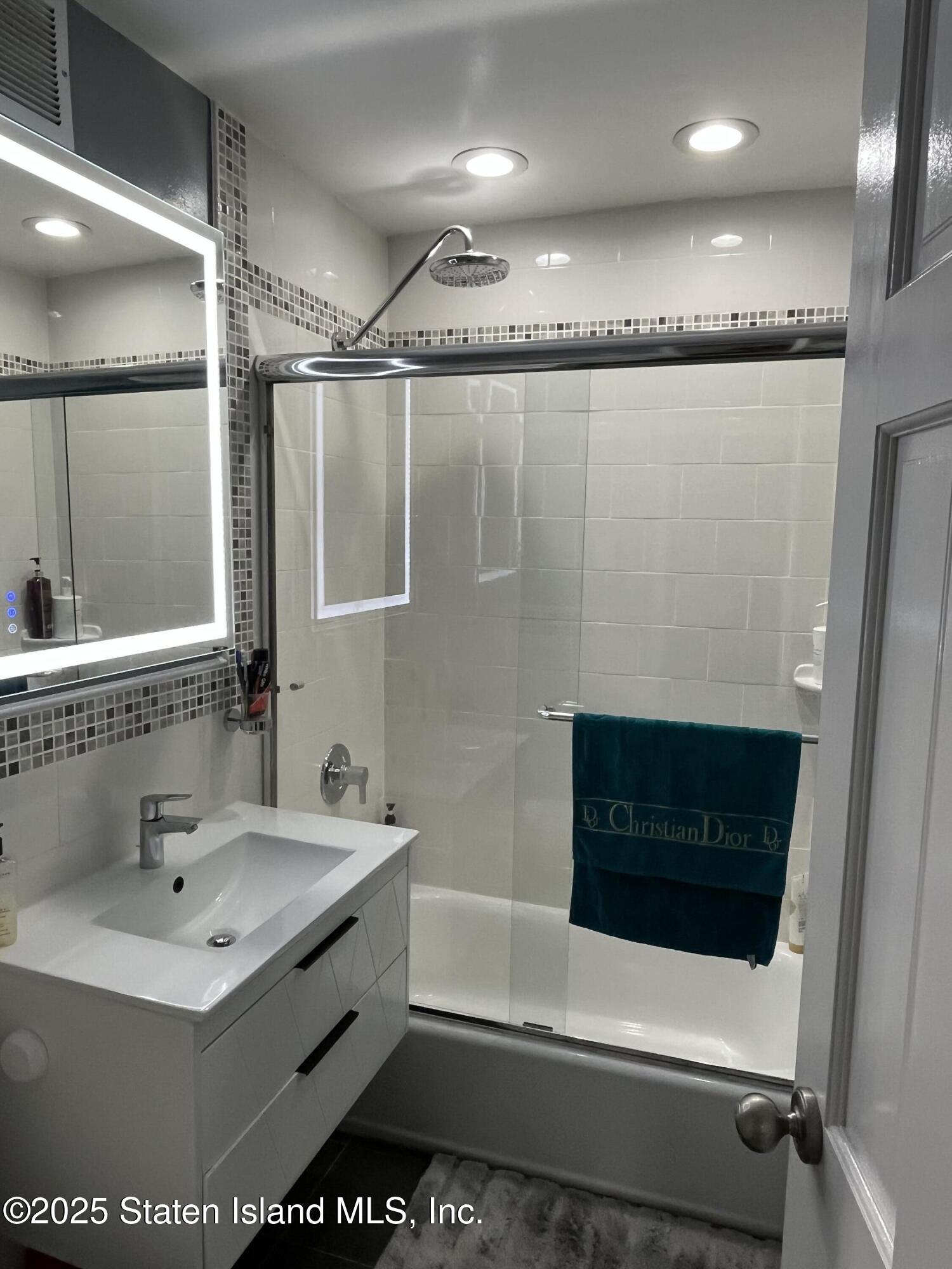 1000 Clove Road, Unit 6O & 6P Staten Island, NY 10301 - Photo 27 of 45 a bathroom with a sink a toilet and shower