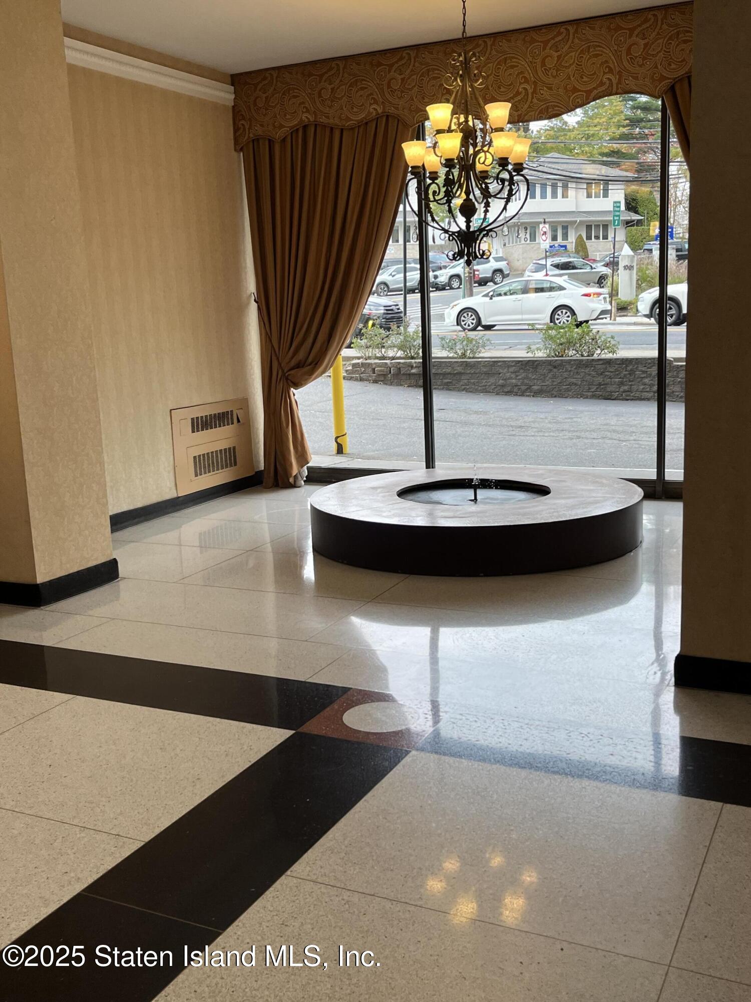 1000 Clove Road, Unit 6O & 6P Staten Island, NY 10301 - Photo 5 of 45 a view of a living room with a floor to ceiling window and chandelier
