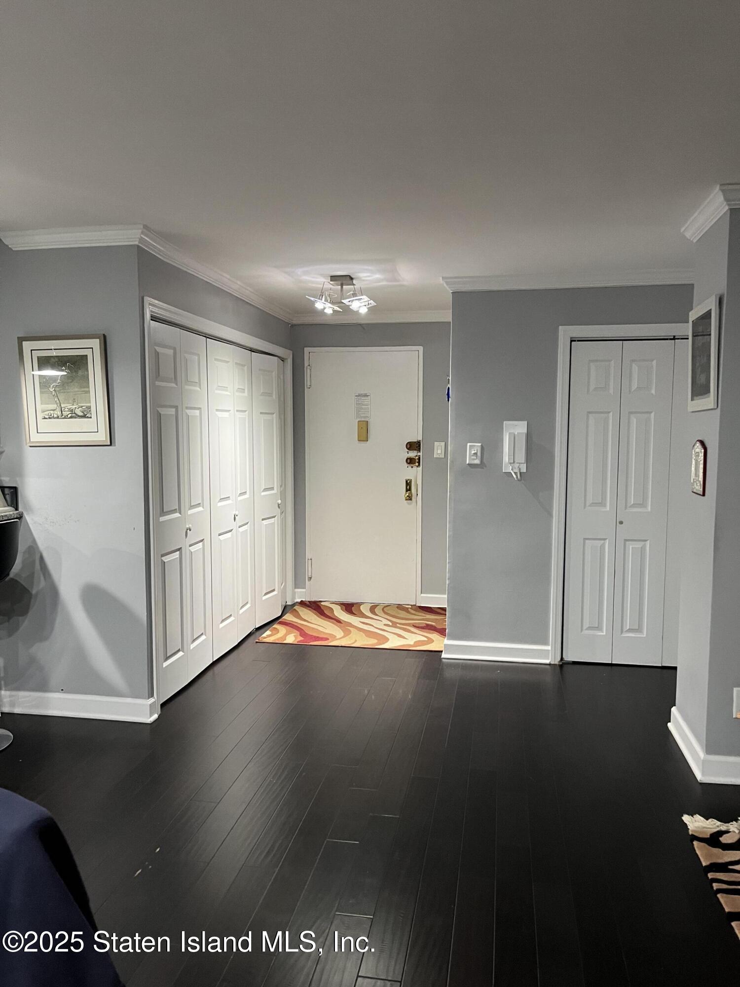 1000 Clove Road, Unit 6O & 6P Staten Island, NY 10301 - Photo 7 of 45 an empty room with wooden floor and windows