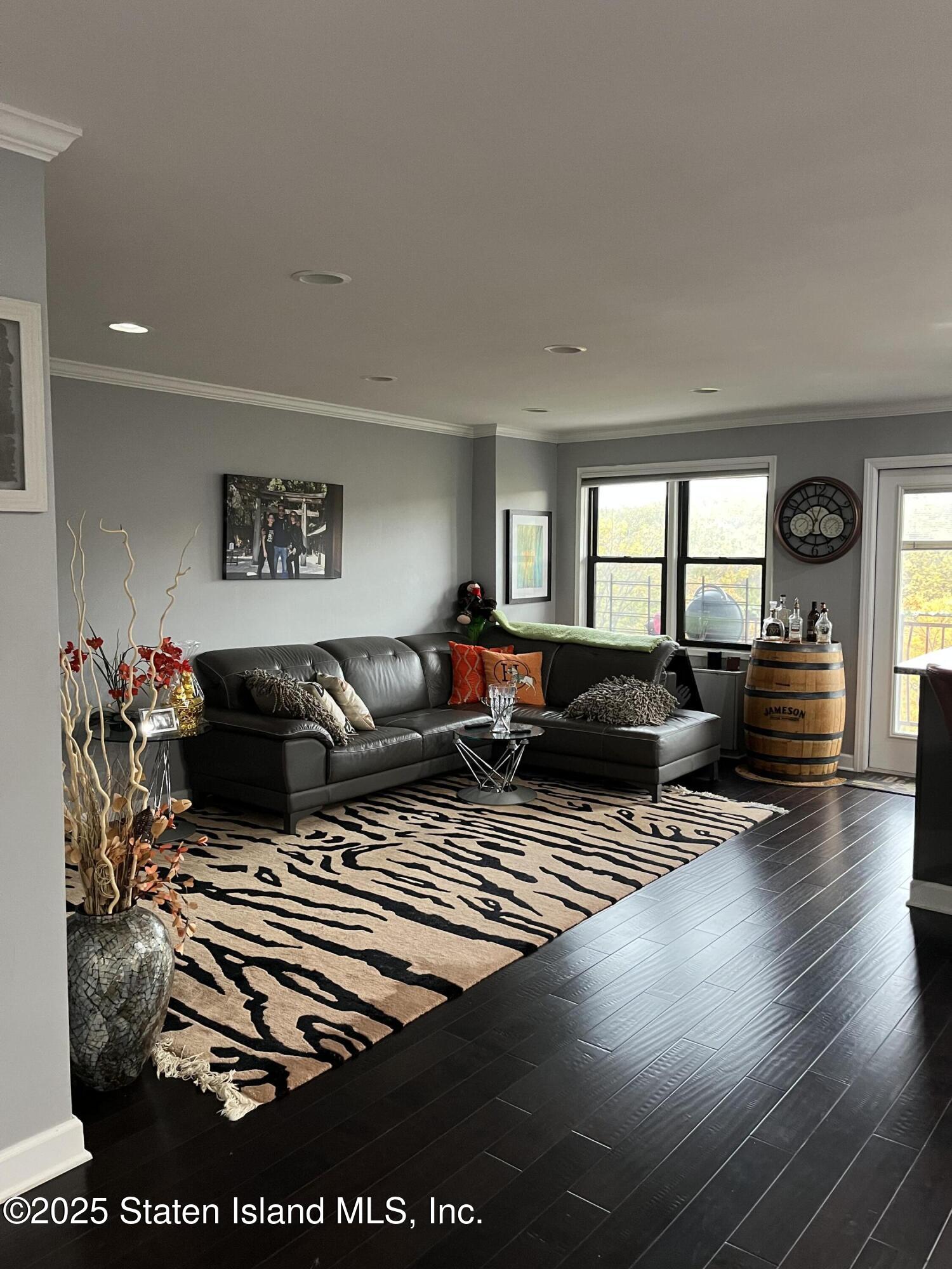 1000 Clove Road, Unit 6O & 6P Staten Island, NY 10301 - Photo 9 of 45 a living room with furniture and a flat screen tv