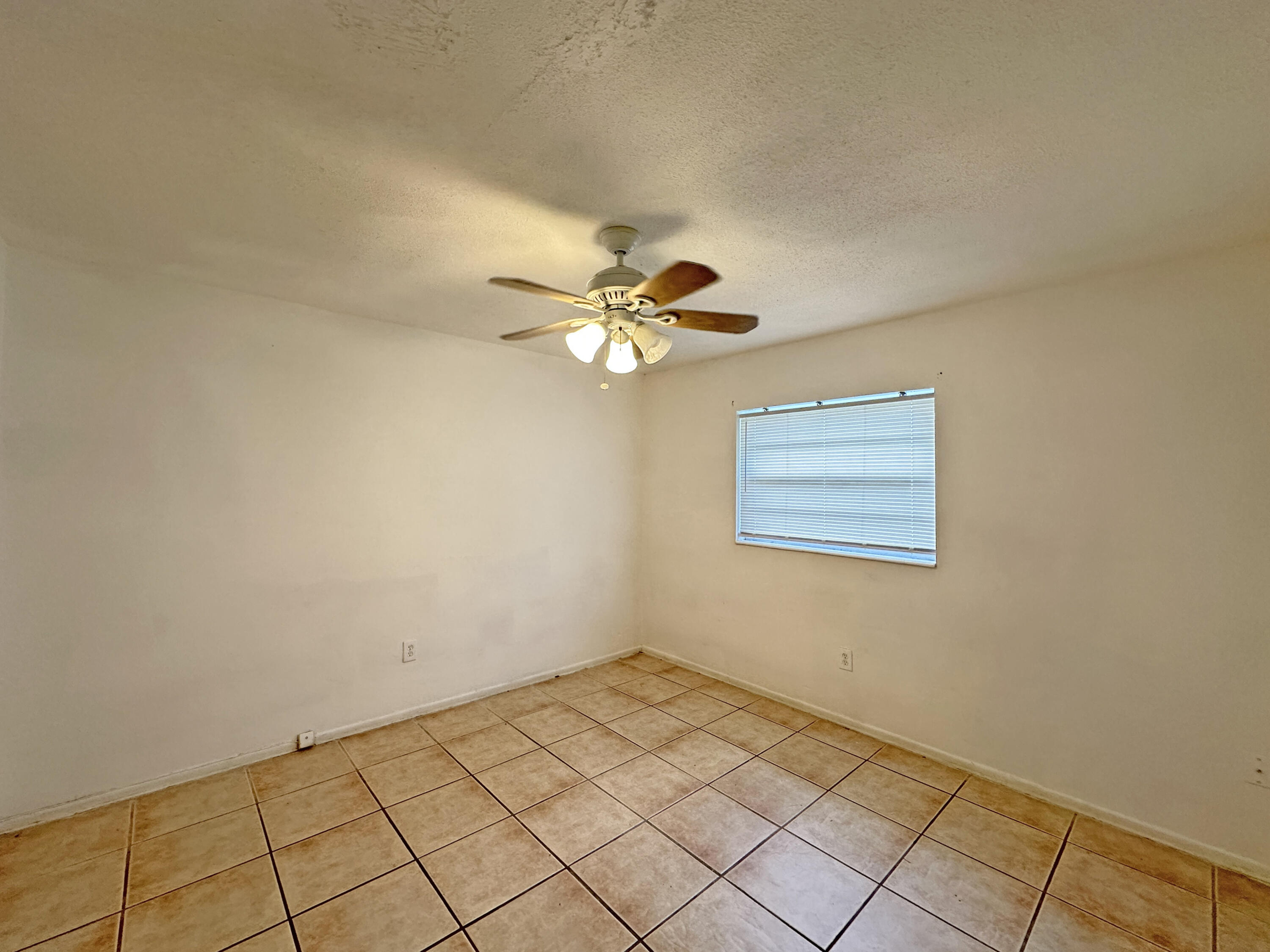 1107 North 21st Street, Unit A & B Fort Pierce, FL 34950 - Photo 19 of 24 a view of a room with a fan and wooden floor