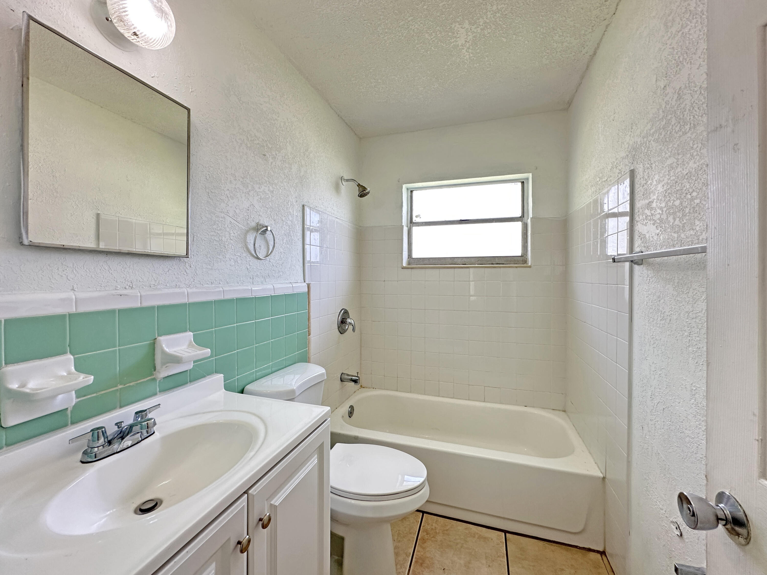 1107 North 21st Street, Unit A & B Fort Pierce, FL 34950 - Photo 22 of 24 a bathroom with a sink a toilet and shower