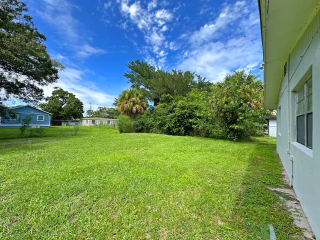a view of a backyard with large trees