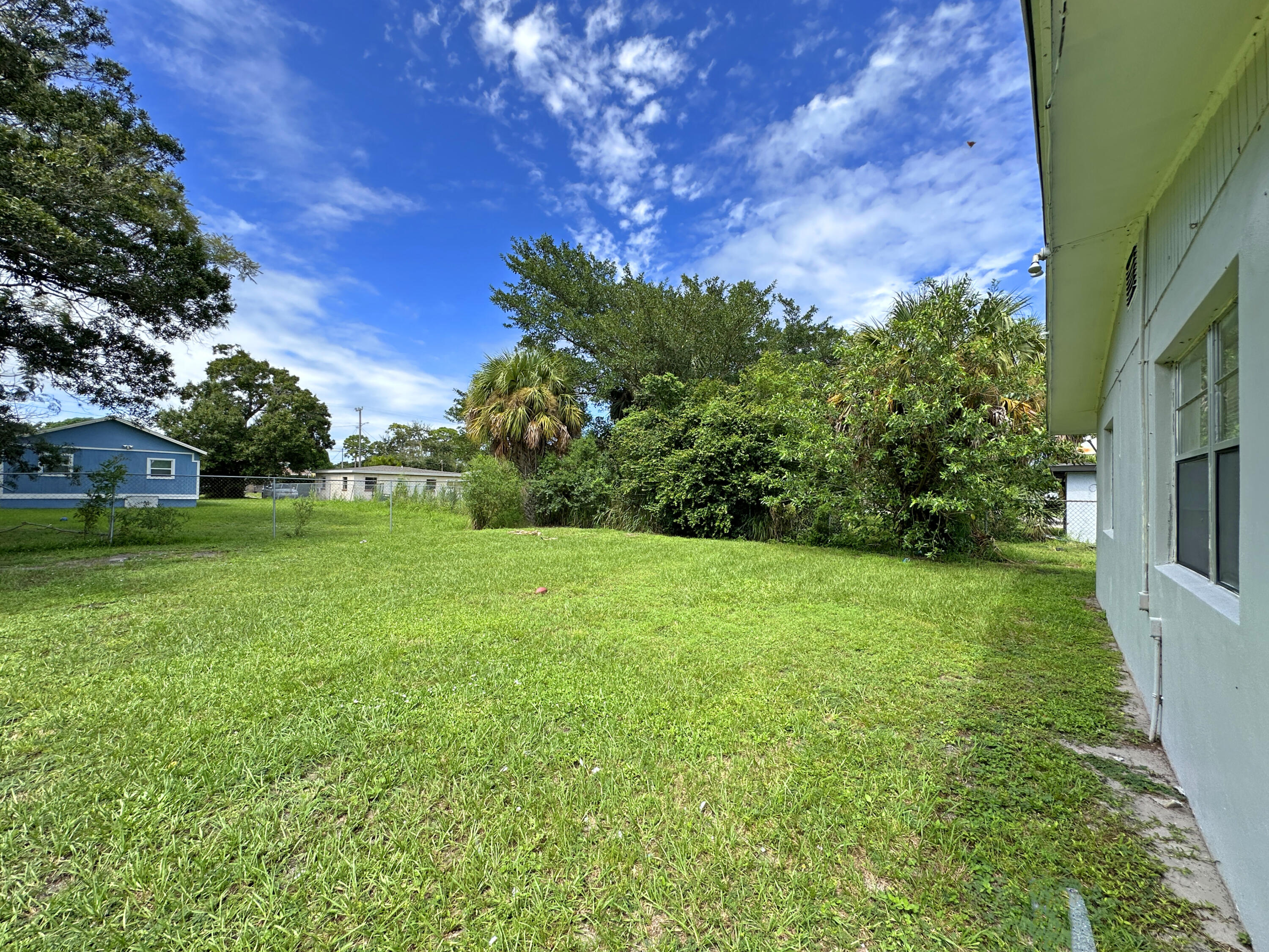1107 North 21st Street, Unit A & B Fort Pierce, FL 34950 - Photo 23 of 24 a view of a backyard with large trees