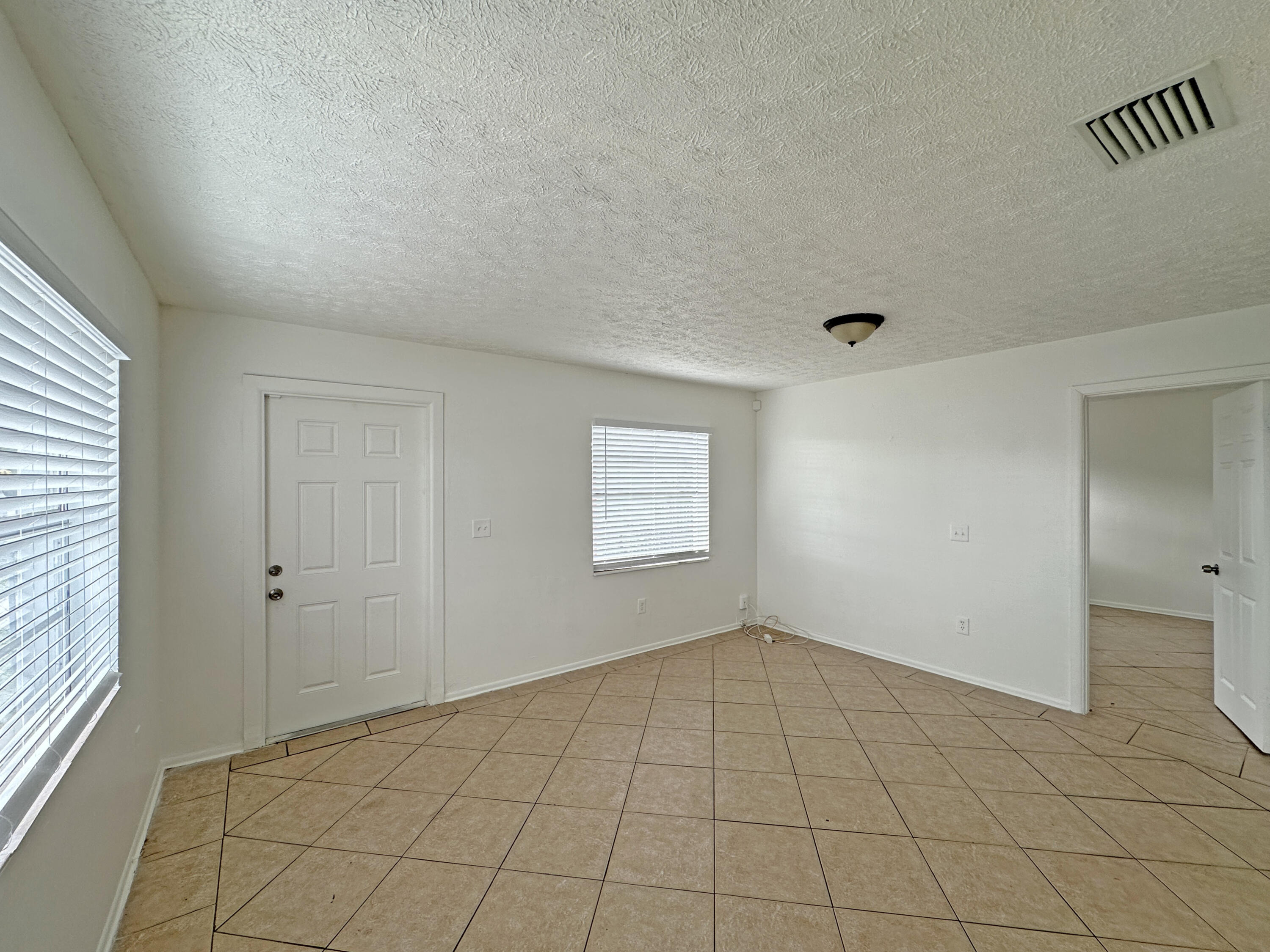 1107 North 21st Street, Unit A & B Fort Pierce, FL 34950 - Photo 3 of 24 a view of an empty room and window