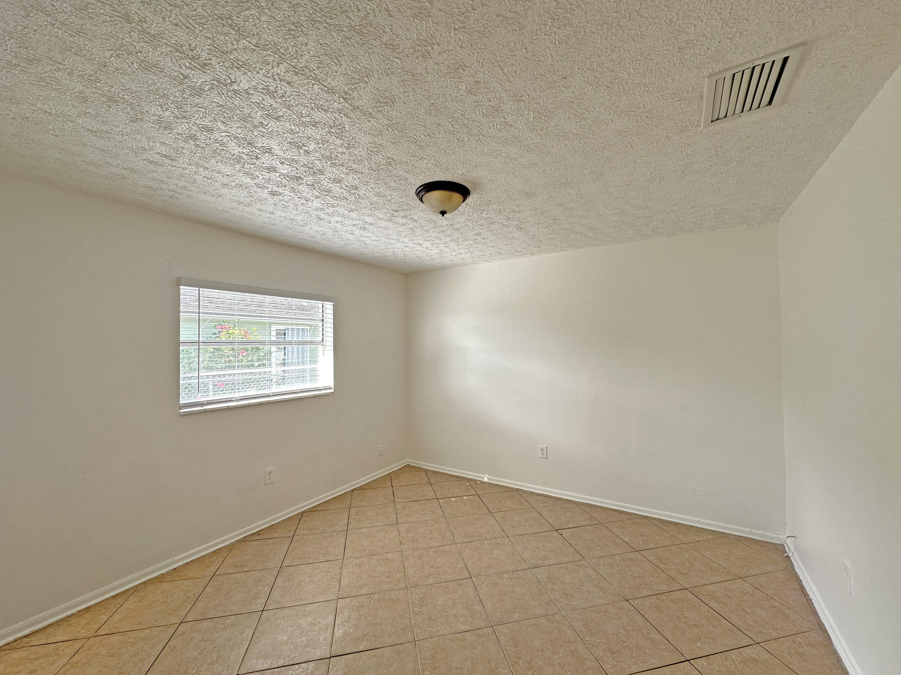 1107 North 21st Street, Unit A & B Fort Pierce, FL 34950 - Photo 5 of 24 an empty room with a workbench