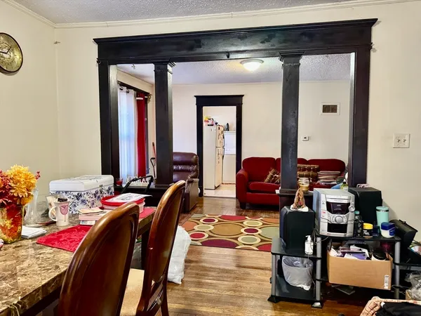 a living room with furniture and wooden floor