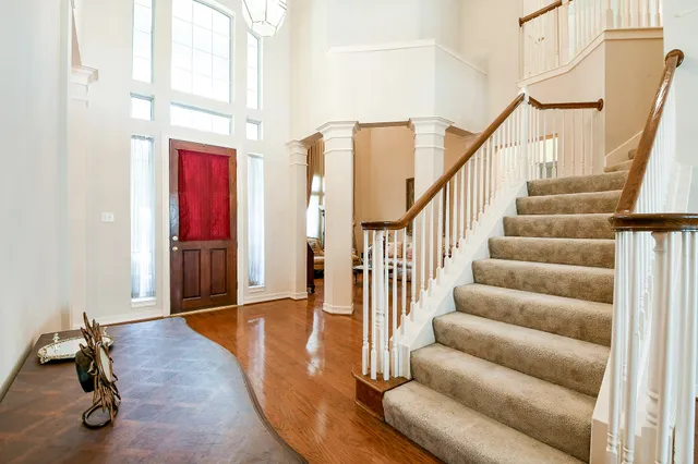 a view of entryway and hall with wooden floor