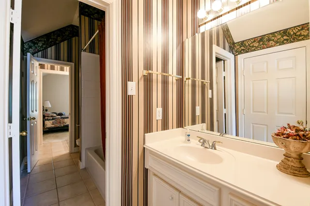 a en suite bathroom with a sink and mirror