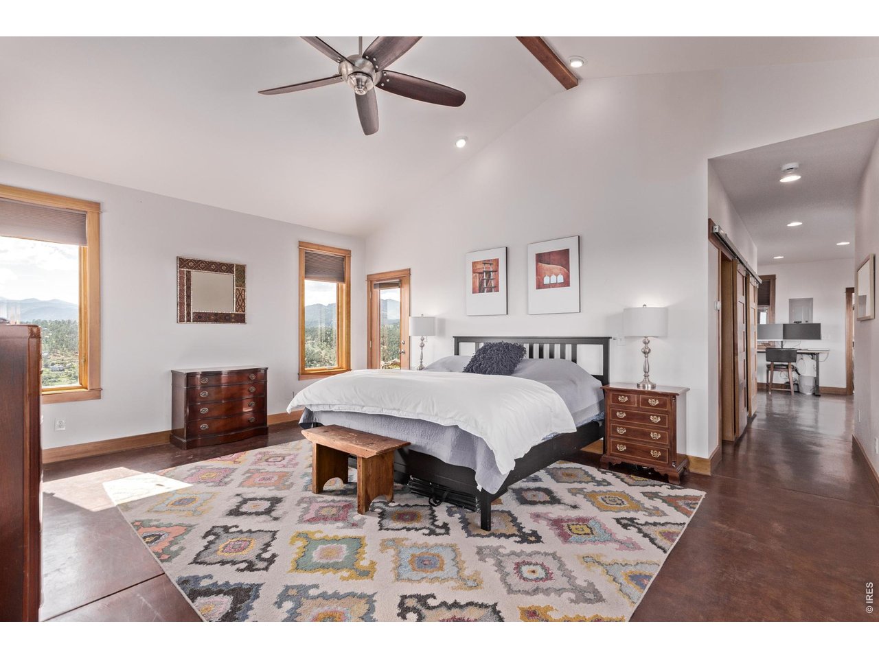 399 Northview Road Berthoud, CO 80513 - Photo 16 of 39 a bedroom with a bed a dresser and wooden floor