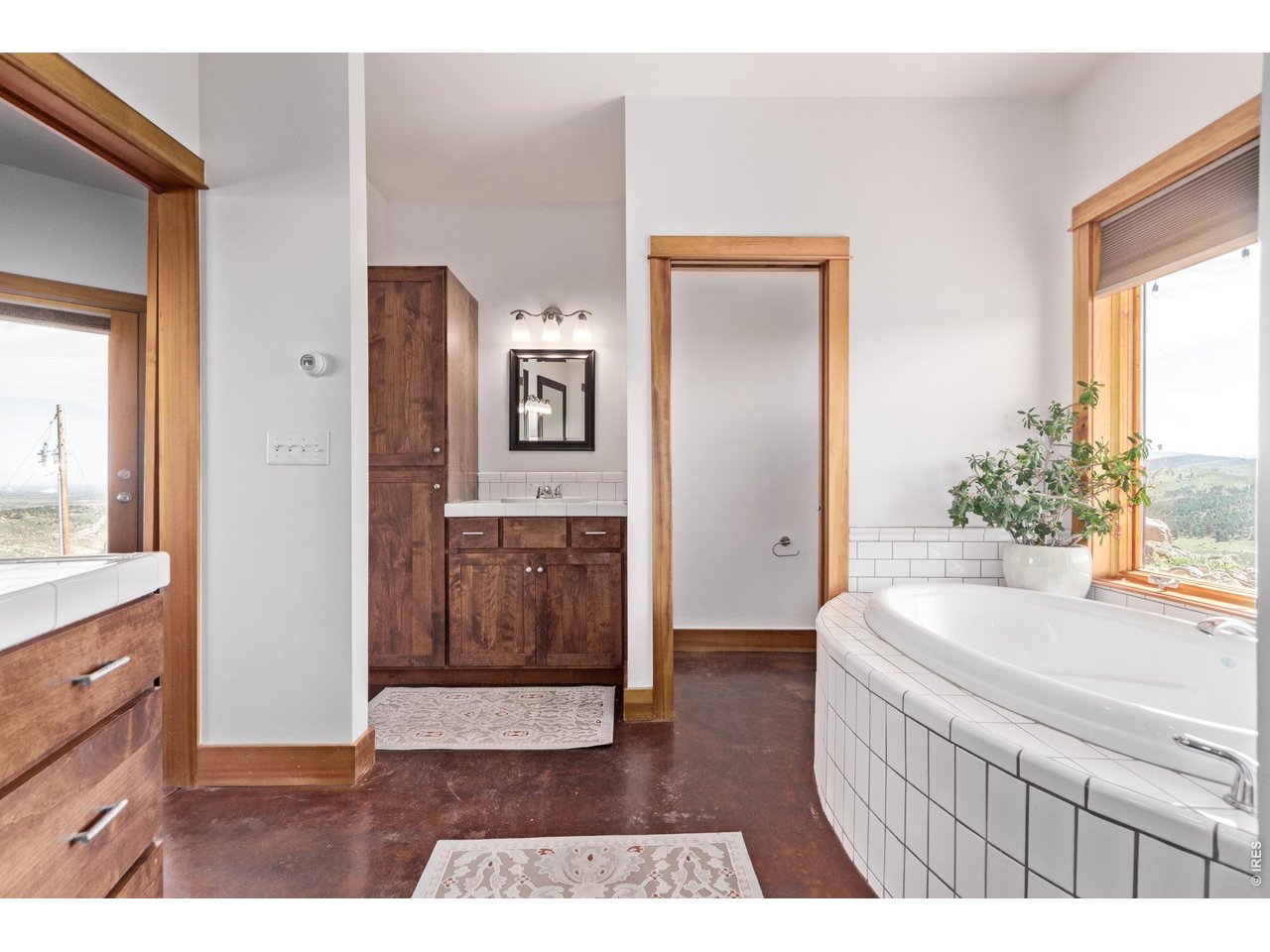 399 Northview Road Berthoud, CO 80513 - Photo 20 of 39 a living room with a sink and a large mirror with wooden floor