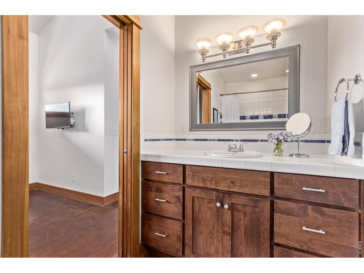 399 Northview Road Berthoud, CO 80513 - Photo 28 of 39 a bathroom with a sink a mirror and a vanity