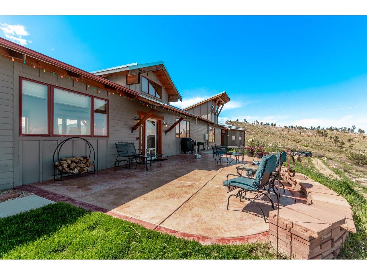 399 Northview Road Berthoud, CO 80513 - Photo 3 of 39 a view of a patio with table and chairs with wooden floor and fence
