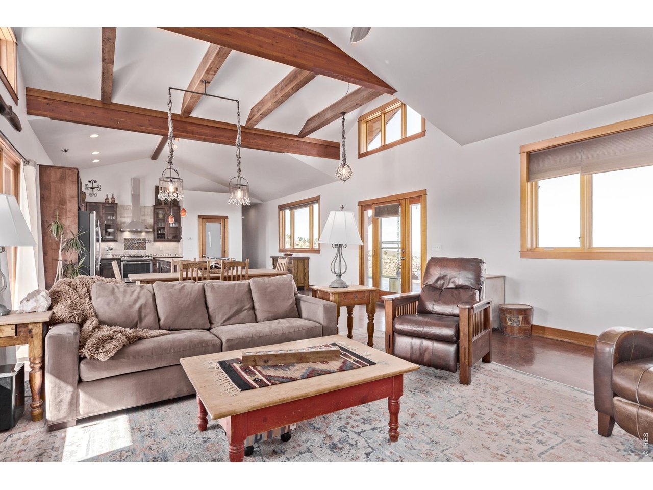 399 Northview Road Berthoud, CO 80513 - Photo 6 of 39 a living room with furniture a flat screen tv and a table
