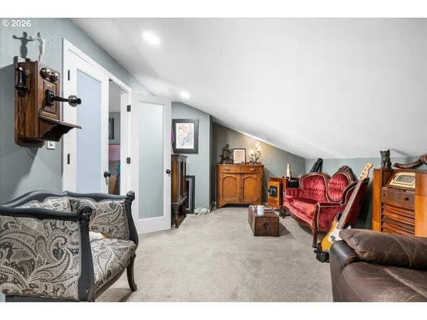 a living room with furniture a flat screen tv and gym equipment