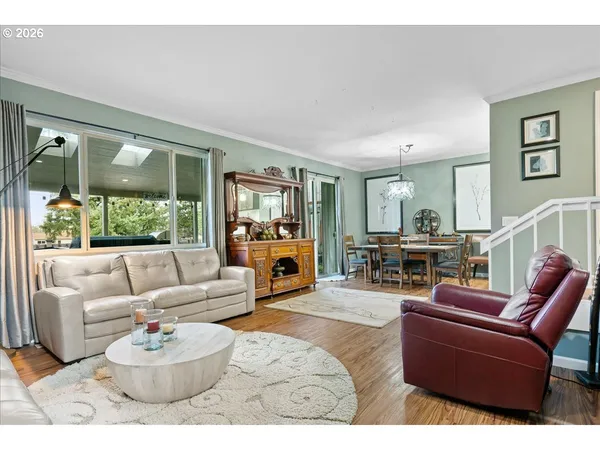 a living room with furniture a fireplace and a large window