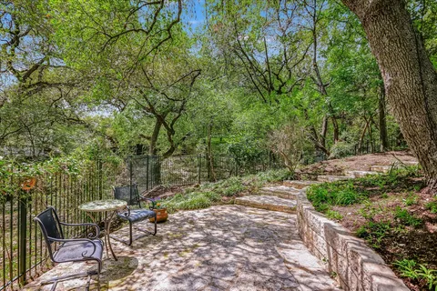 a backyard of a house with table and chairs