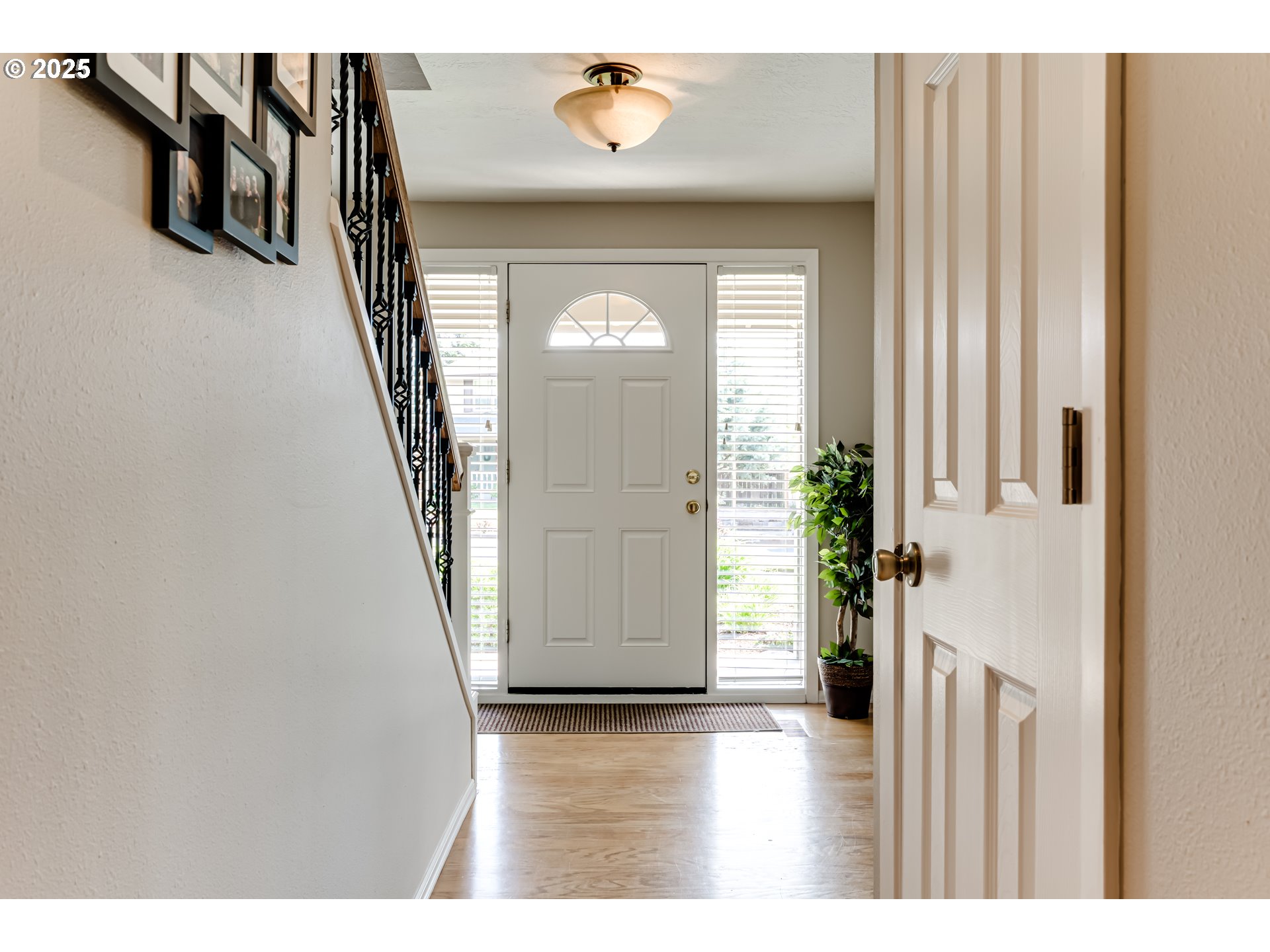 2852 Metolius Drive Eugene, OR 97408 - Photo 14 of 48 a view of a hallway with wooden floor and stairs