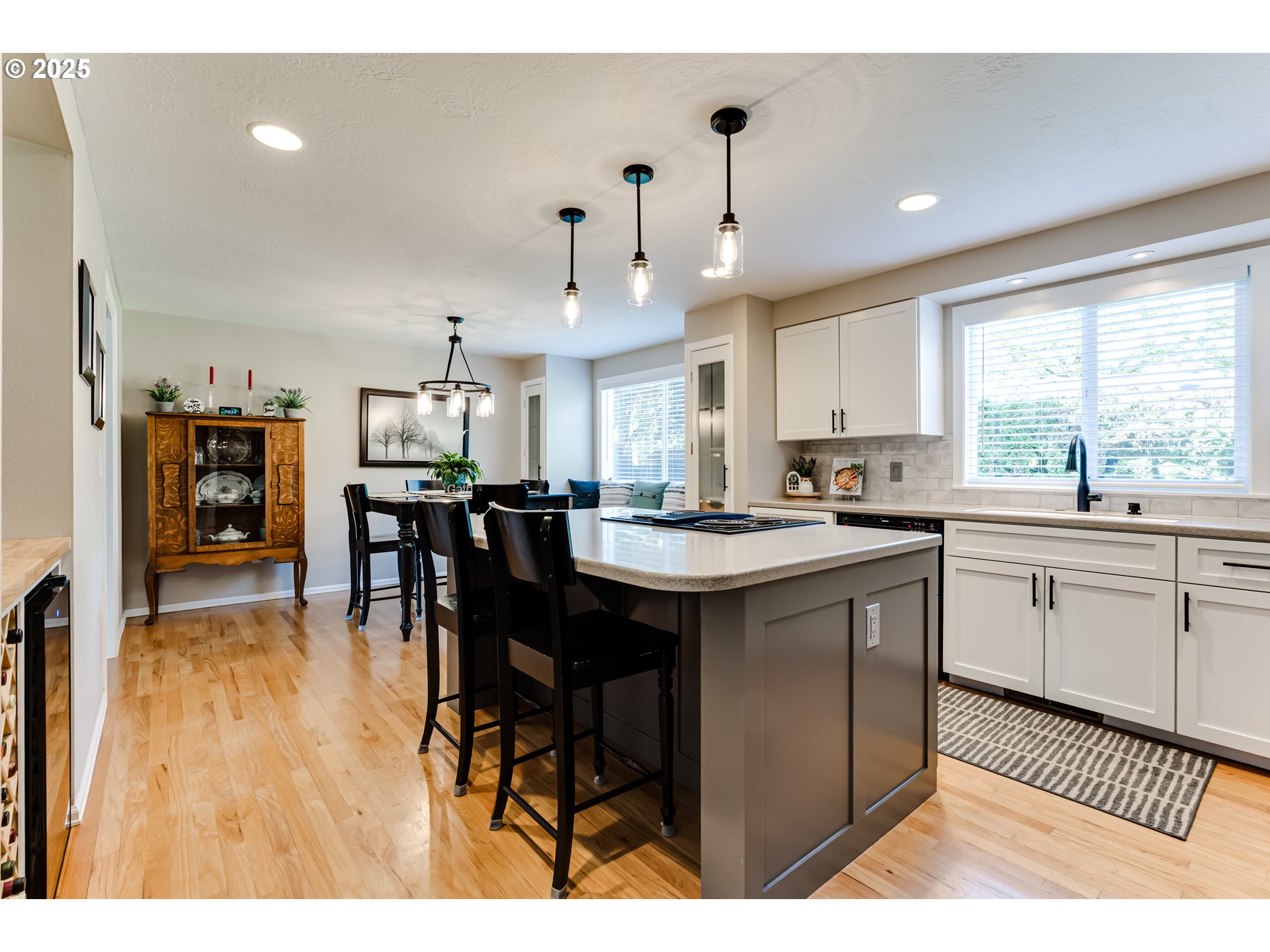 2852 Metolius Drive Eugene, OR 97408 - Photo 15 of 48 a kitchen with stainless steel appliances kitchen island granite countertop a table chairs and a refrigerator