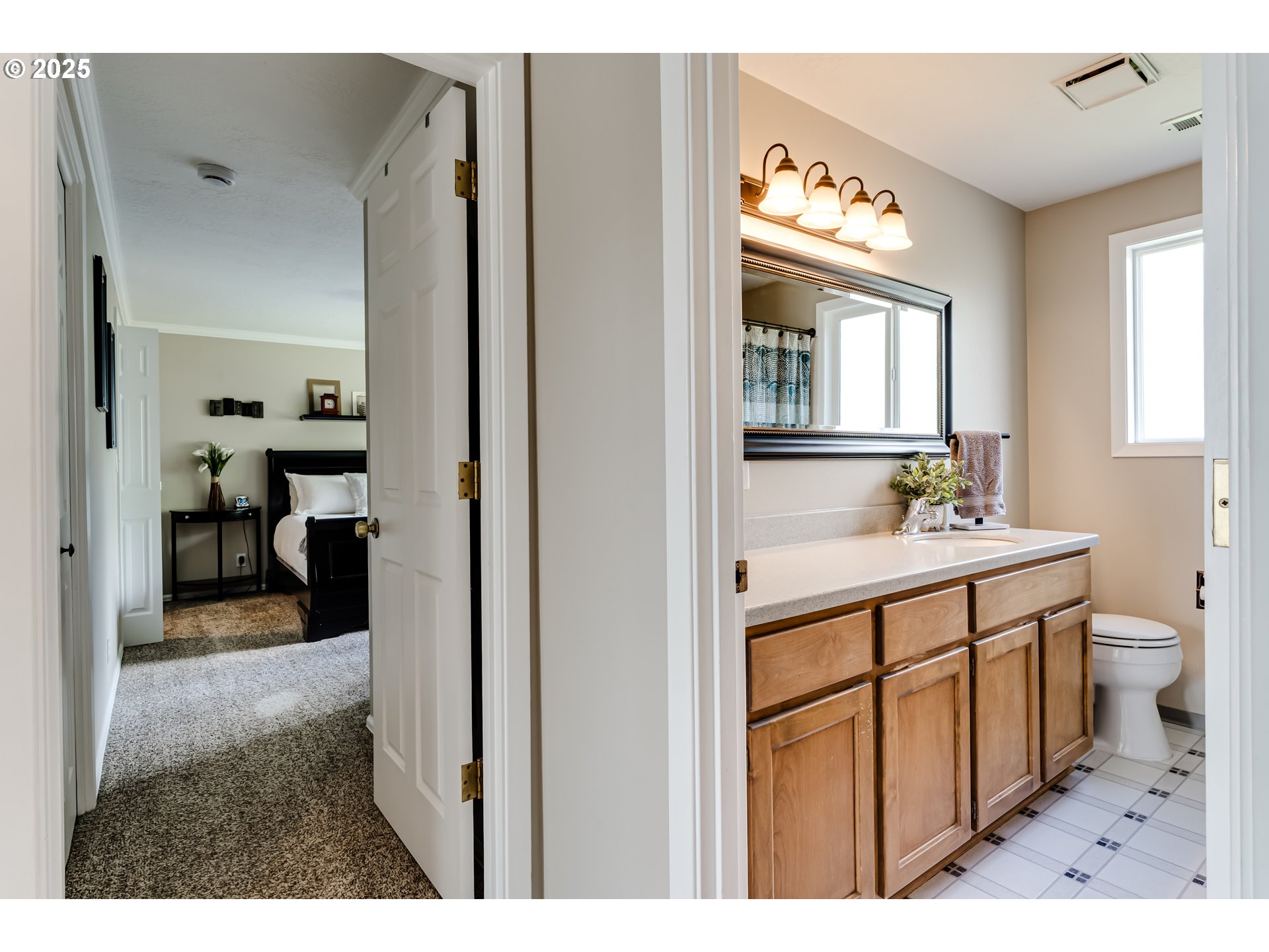 2852 Metolius Drive Eugene, OR 97408 - Photo 35 of 48 a bathroom with a toilet a sink a mirror and a window