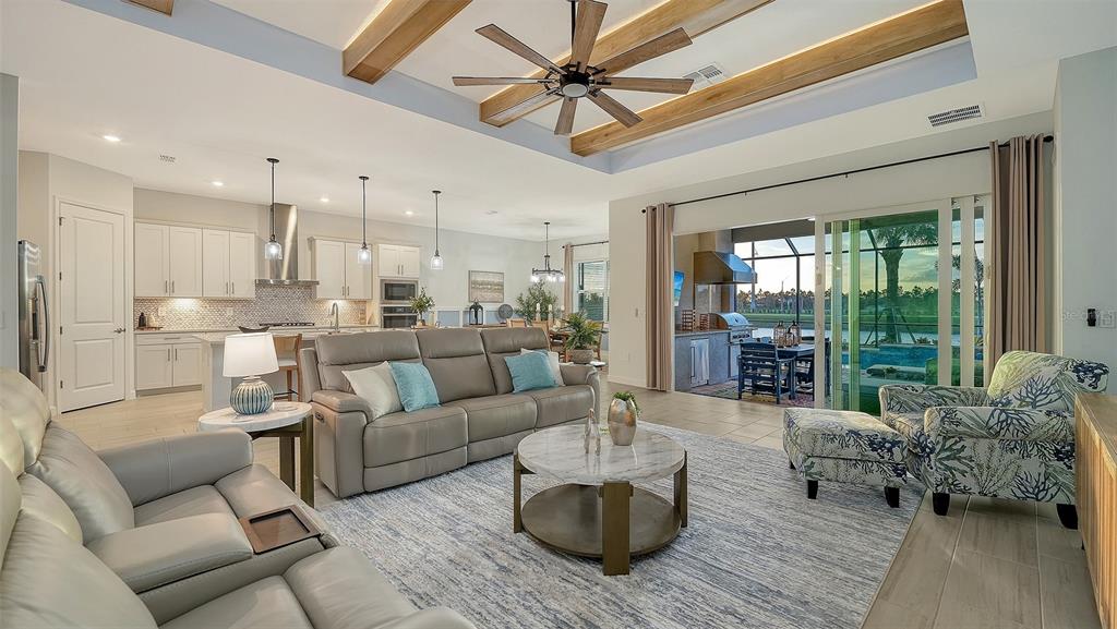 5612 Lightning Whelk Lane Lakewood Ranch, FL 34211 - Photo 11 of 44 a living room with furniture and a large window
