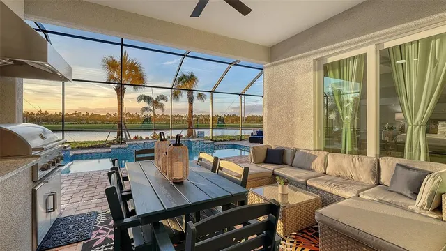 a dining room with furniture and a floor to ceiling window