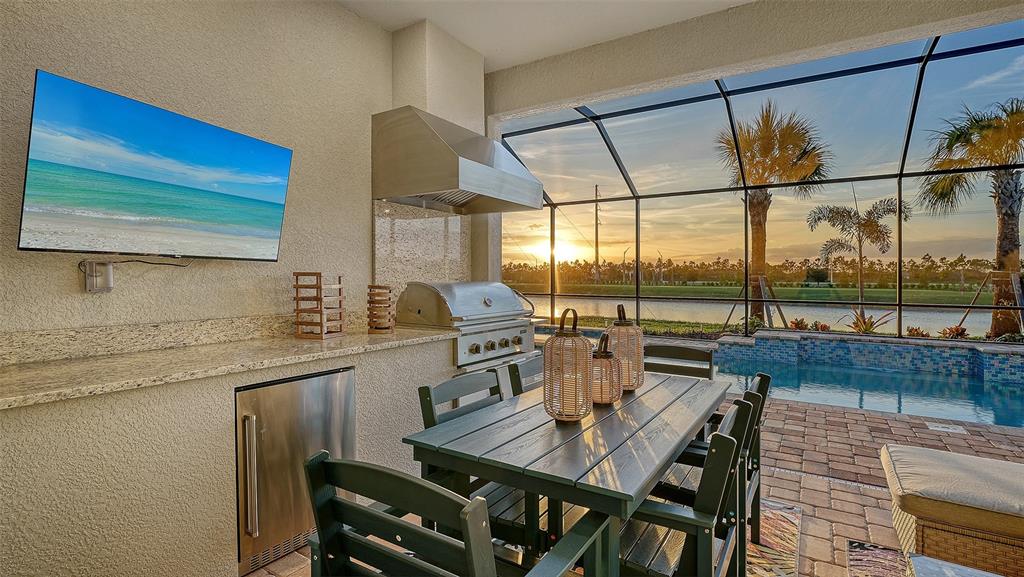 5612 Lightning Whelk Lane Lakewood Ranch, FL 34211 - Photo 14 of 44 a open kitchen with a table and chairs